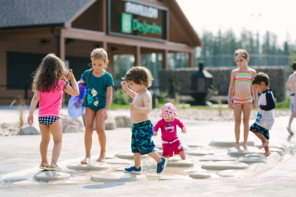 The Future of Public Spaces in a Hotter Climate Families enjoying a public aquatic play space
